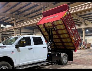 Red stake body dump truck